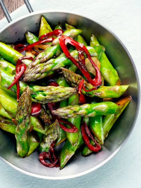 Overhead asparagus stir fry with soy sauce garlic and chilli.