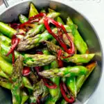 Overhead asparagus stir fry with soy sauce garlic and chilli featuring a title overlay.