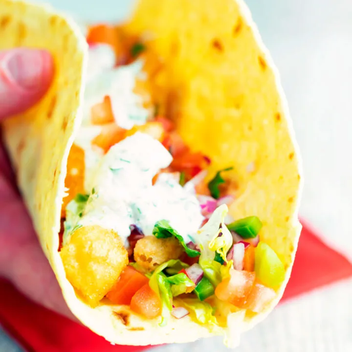 Crispy fried cod fish tacos with a salsa and coriander crema.