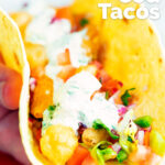 Beer battered crispy cod fish tacos in a corn tortilla featuring a title overlay.