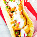 Overhead beer battered crispy cod fish tacos in a corn tortilla featuring a title overlay.