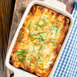 Overhead minced beef stuffed cannelloni pasta topped with bechamel and mozzarella cheese featuring a title overlay.