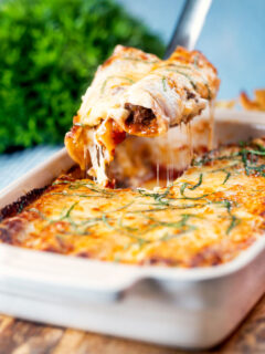 Portion of beef stuffed cannelloni with a bechamel topping removed from a baking dish.