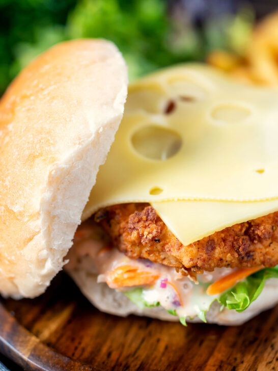 Buttermilk fried chicken burger with a bitter chicory slaw, topped with Swiss cheese.