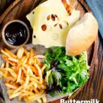 Buttermilk fried chicken burger with Swiss cheese served with French fries featuring a title overlay.