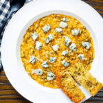 Overhead roasted butternut squash and sage risotto served with Roquefort cheese.