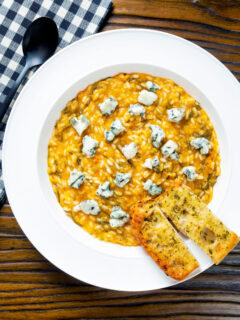 Overhead roasted butternut squash and sage risotto served with Roquefort cheese.