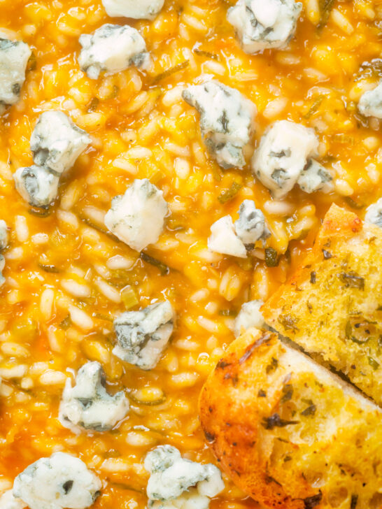 Overhead close-up butternut squash and sage risotto served with Roquefort cheese.