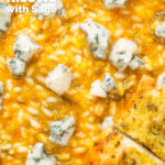 Overhead close-up butternut squash and sage risotto served with Roquefort cheese featuring a title overlay.