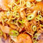 Overhead close-up British Chinese takeaway style chicken chow mein noodle stir fry.