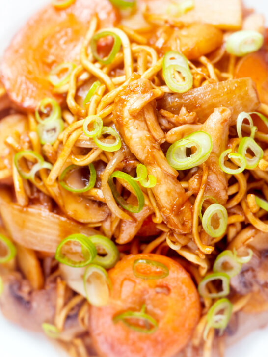 Overhead close-up British Chinese takeaway style chicken chow mein noodle stir fry.