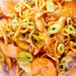 Overhead close-up British Chinese takeaway style chicken chow mein noodle stir fry featuring a title overlay.