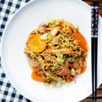 Overhead British Chinese takeaway style chicken chow mein noodle stir fry.