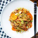 Overhead British Chinese takeaway style chicken chow mein noodle stir fry featuring a title overlay.