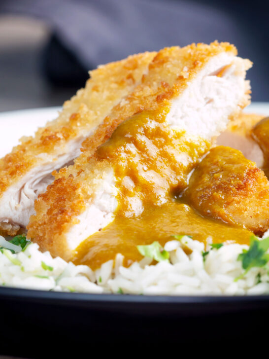 Close-up crispy fried chicken katsu curry with homemade kare sauce served with rice.