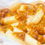 British chip shop chips served with a homemade chippy curry sauce featuring a title overlay.