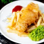 Chip shop style fried battered fish served with chips and mushy peas.