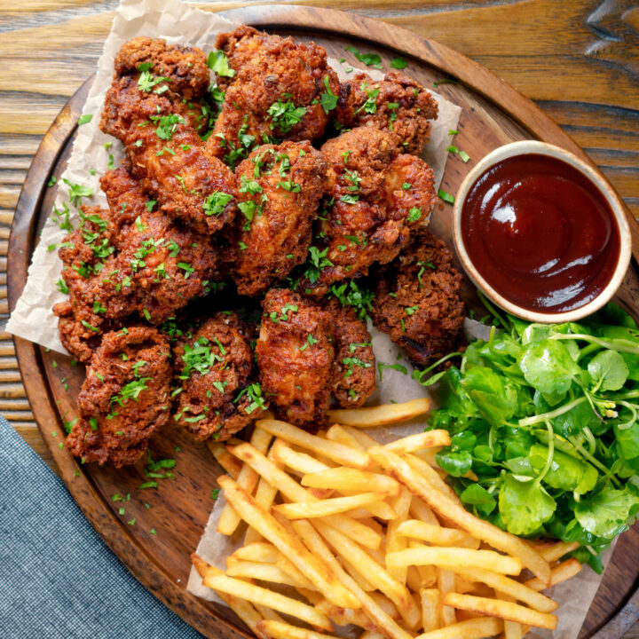 Super crispy and spicy fried buttermilk chicken wings served with fries, salad and BBQ sauce.