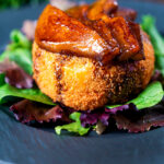 Fried camembert cheese with a couscous crumb served with balsamic glazed pears.