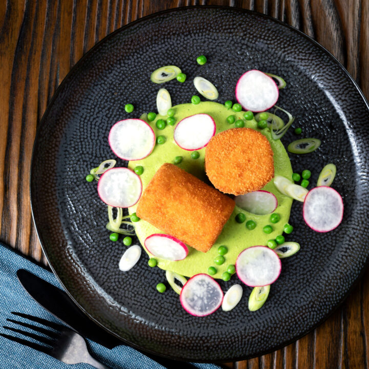 Deep fried breaded goat cheese with pea puree, radishes, spring onions and peas.