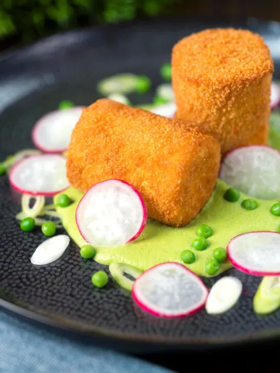 Fried crumbed goat cheese with sweet pea puree, radishes and spring onions.