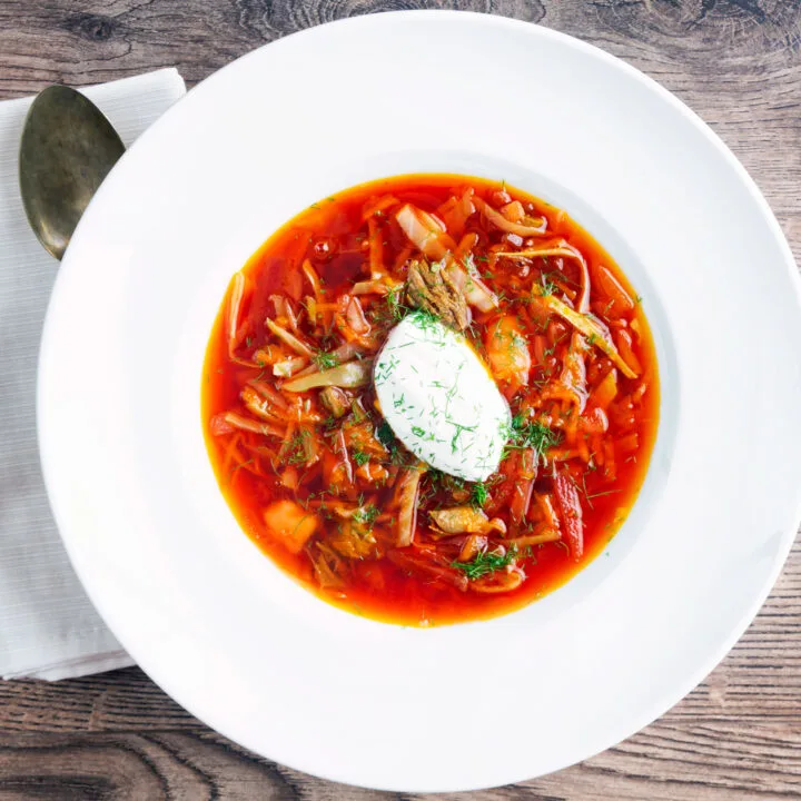 Russian influenced beef and beetroot borscht soup with sour cream and dill.