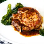 Thick cut honey mustard pork chops with roasted tenderstem broccoli and mashed potato featuring a title overlay.