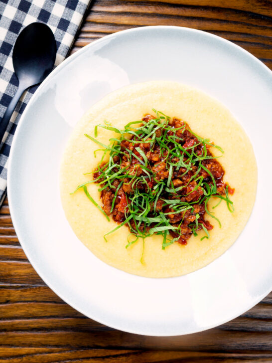 Overhead sausage ragu made with Italian sausages and tomatoes served with polenta.