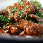 Overhead close-up kaleji masala or Indian lambs liver curry.