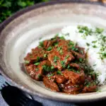 Kaleji masala or Indian lambs liver curry served with rice and naan bread.