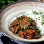 Kaleji masala or Indian lambs liver curry served with rice and naan bread featuring a title overlay.