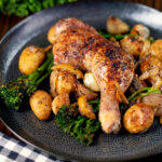 Baked chicken leg with preserved lemons, potatoes, garlic and broccoli.