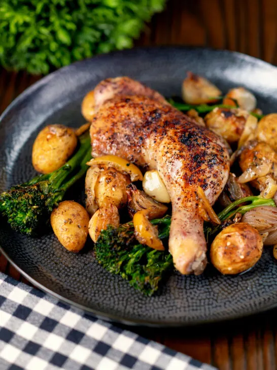 Baked chicken leg with preserved lemons, potatoes, garlic and broccoli.