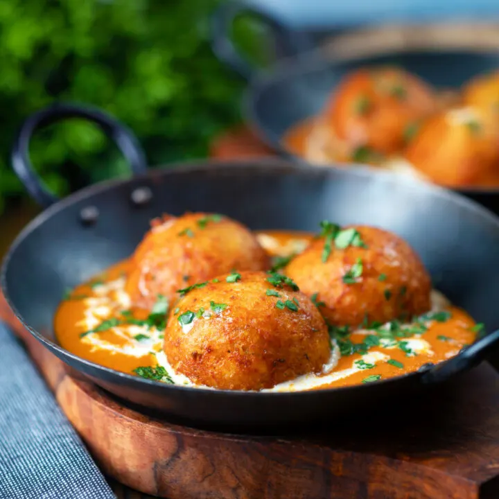 Malai kofta fried paneer and potato ball curry in a spicy gravy.