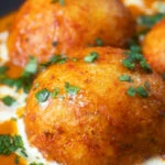 Close-up malai kofta, vegetarian paneer and potato "meatball" curry.