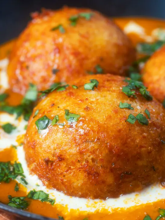 Close-up malai kofta, vegetarian paneer and potato "meatball" curry.