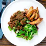 Overhead peri peri chicken livers served with beetroot salad and wedges,
