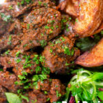 Overhead close-up peri peri chicken livers served with beetroot salad and wedges featuring a title overlay.