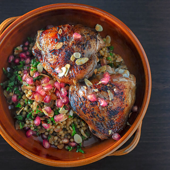 Pomegranate molasses glazed chicken thighs with giant couscous and almonds.