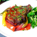 Tray baked paprika pork chop with red wine and honey bell peppers and onions.