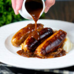 BBQ and mustard sauce gravy poured over slow cooker pork sausages.