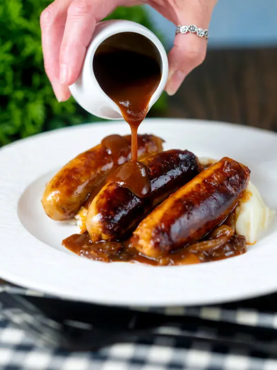 BBQ and mustard sauce gravy poured over slow cooker pork sausages.