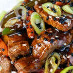 Close up Chinese takeaway style beef in black bean sauce with green peppers.
