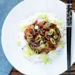 Overhead Chinese takeaway style beef in black bean sauce with green peppers.