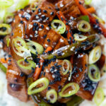 Close-up Overhead Chinese takeaway style beef in black bean sauce with green peppers.