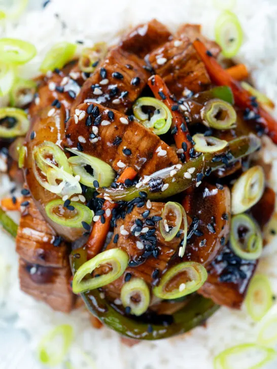 Close-up Overhead Chinese takeaway style beef in black bean sauce with green peppers.