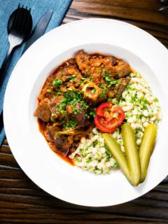 Overhead Hungarian birkapörkölt or mutton stew served with nokedli.