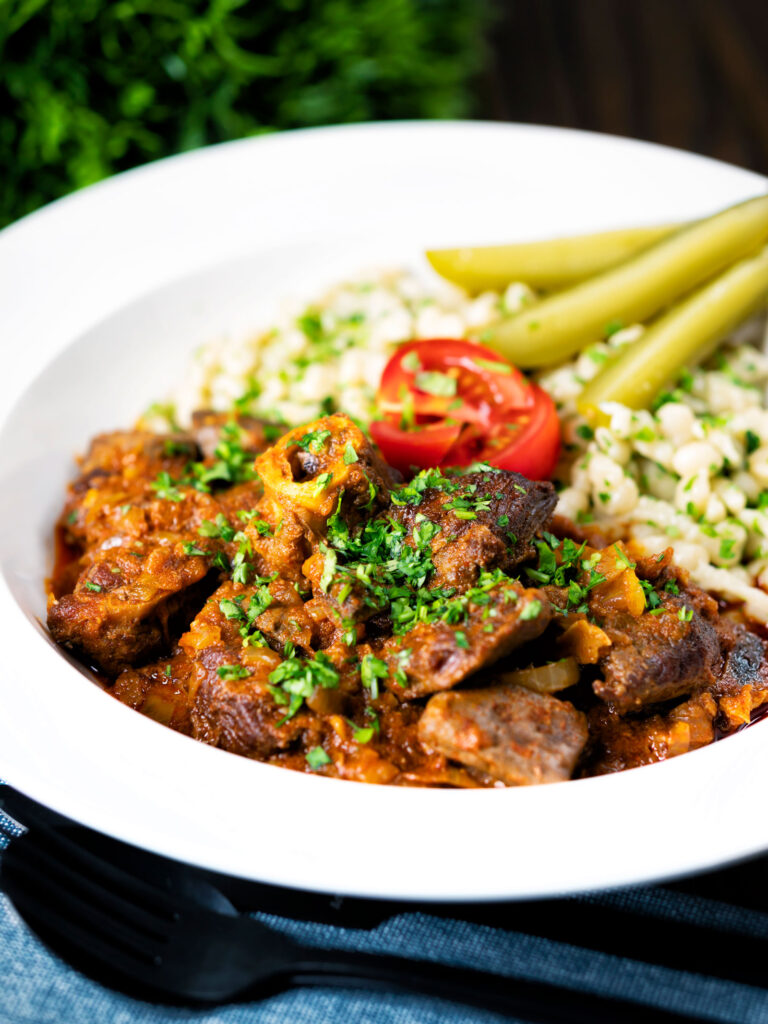 Hungarian birkapörkölt or mutton stew served with nokedli.