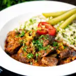 Hungarian birkapörkölt or mutton stew served with nokedli featuring a title overlay.