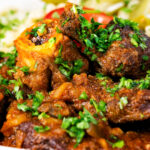 Close-up mutton stew or Hungarian birkapörkölt, served with nokedli.